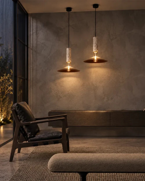Two Asteria Gold pendant lights suspended above a contemporary living room seating area