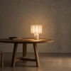 Astra Table Lamp Contemporary Interior Astra white decorative table lamp displayed on a round wooden table in a warm minimalist interior
