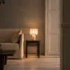 Astra Table Lamp Modern Bedroom Astra table lamp with a softly illuminated pleated shade on a bedside table beside a contemporary bed