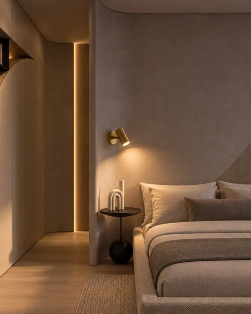 Aurelio Gold Wall Lamp Modern Bedroom Aurelio gold wall spotlight providing warm illumination beside a bed in a contemporary bedroom