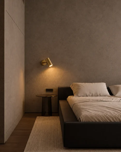 Aurelio LED Wall Spotlight Bedroom Aurelio electroplated gold wall lamp mounted above a bedside table in a minimalist bedroom