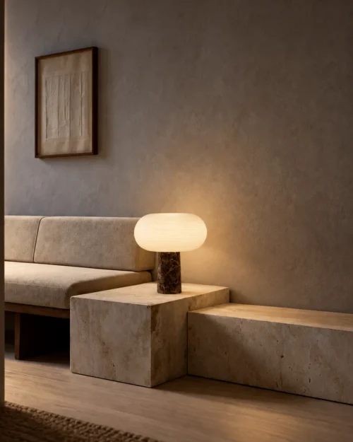 Auren Table Lamp Contemporary Interior Auren table lamp with glowing rounded shade on a stone side table beside a sofa