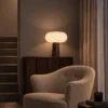 Auren Table Lamp Living Room Interior Auren table lamp displayed on a wooden cabinet beside an upholstered armchair