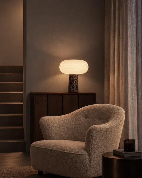 Auren Table Lamp Living Room Interior Auren table lamp displayed on a wooden cabinet beside an upholstered armchair
