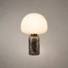 Avorio table lamp with a rounded white dome shade and dark marble-patterned cylindrical base
