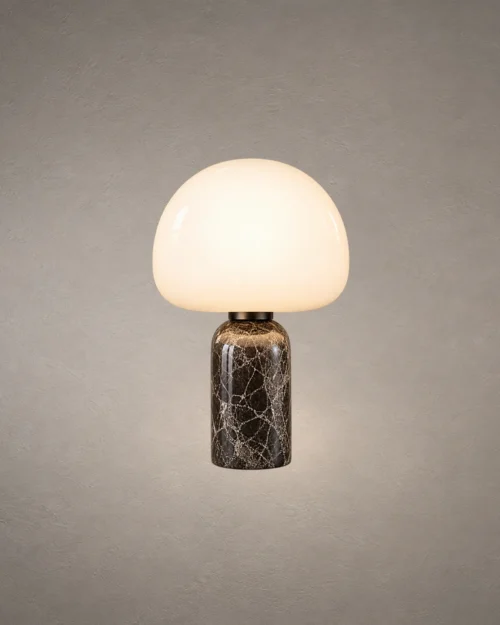 Avorio table lamp with a rounded white dome shade and dark marble-patterned cylindrical base