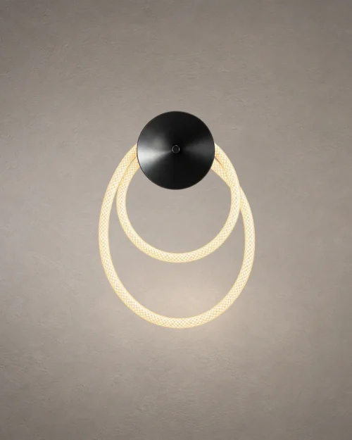 Ayla modern gun black wall lamp featuring two overlapping illuminated circular rings