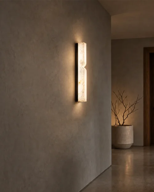 Bianco illuminated wall lamp mounted on a textured wall in a contemporary hallway