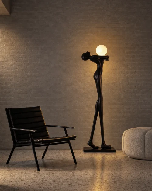 Civil Love black human-inspired floor lamp with spherical lighting beside a modern accent chair