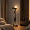 Civil Love sculptural floor lamp displayed beside a lounge chair in a warm contemporary living room