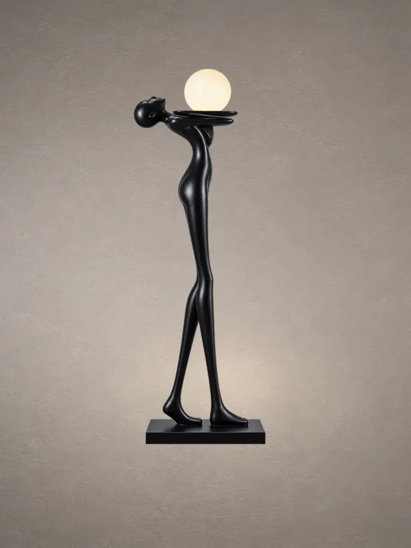 Civil Love black sculptural floor lamp featuring an elongated human figure holding a glowing spherical light