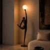 Civil Reaching Floor Lamp Modern Living Room Civil Reaching sculptural floor lamp with glowing spherical light beside a sofa in a modern living room
