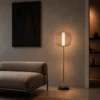 Clymene Floor Lamp displayed beside a sofa in a modern interior