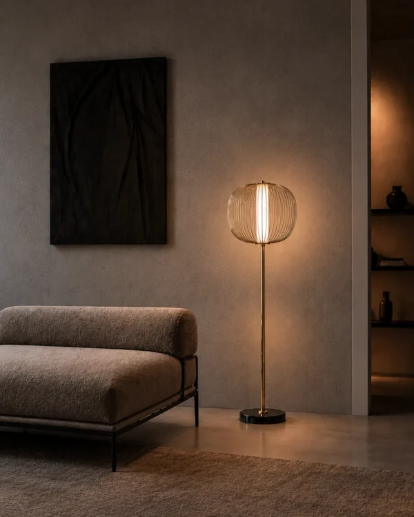 Clymene Floor Lamp displayed beside a sofa in a modern interior