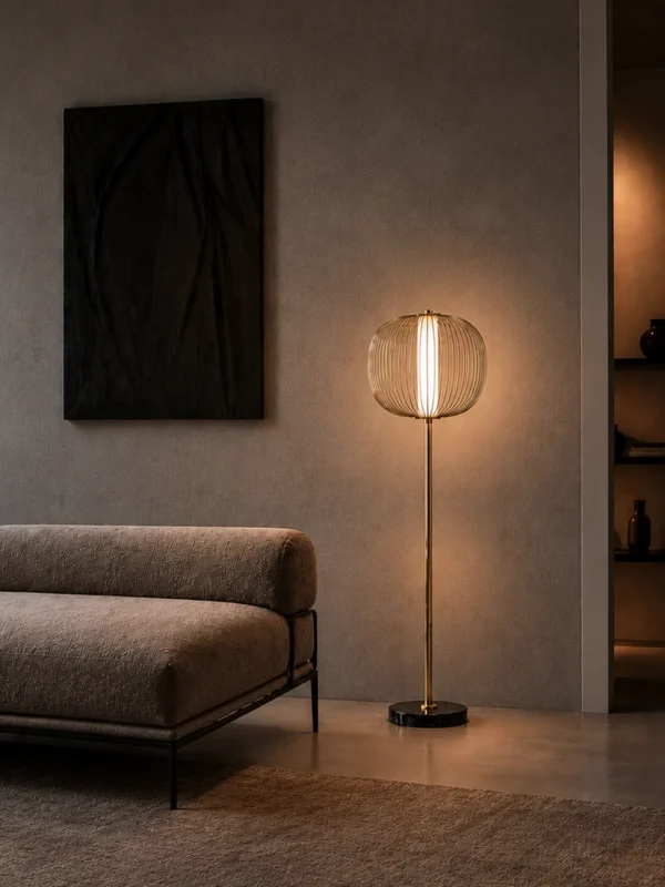 Clymene Floor Lamp displayed beside a sofa in a modern interior