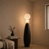 Deimos Floor Lamp Modern Bedroom Deimos black floor lamp with stacked glowing spheres beside a bed in a contemporary bedroom