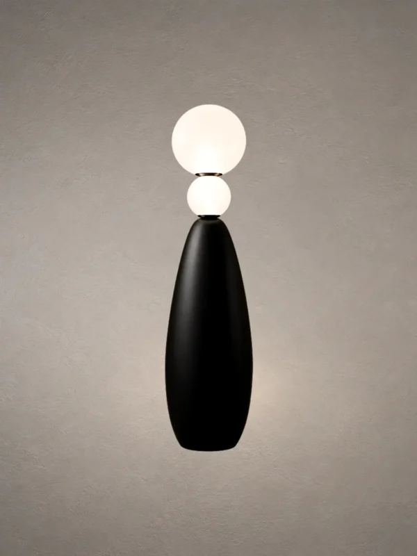 Deimos floor lamp featuring two illuminated white spherical shades and a tapered black base