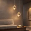 Dione Pendant Light Cognac Glass Interior Two Dione pendant lights with warm Cognac glass suspended beside a contemporary sofa