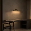 Elanor linear wall lamp illuminating a modern study interior