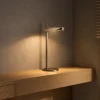 Elian Table Lamp Wooden Console Elian table lamp with Rustic Coffee finish on a wooden console against a textured wall