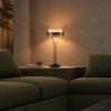 Elion Table Lamp Modern Living Room Elion table lamp displayed on a console behind a green sofa in a contemporary living room