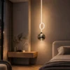 Evadne Pendant Light Modern Bedroom Evadne pendant light with illuminated circular detail beside a contemporary bedroom bed