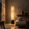 Geremie Floor Lamp Contemporary Living Room Geremie floor lamp with warm illumination beside a lounge chair in a contemporary living room