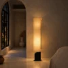 Geremie Floor Lamp Modern Interior Geremie tall cylindrical floor lamp illuminating a warm minimalist interior with an arched doorway