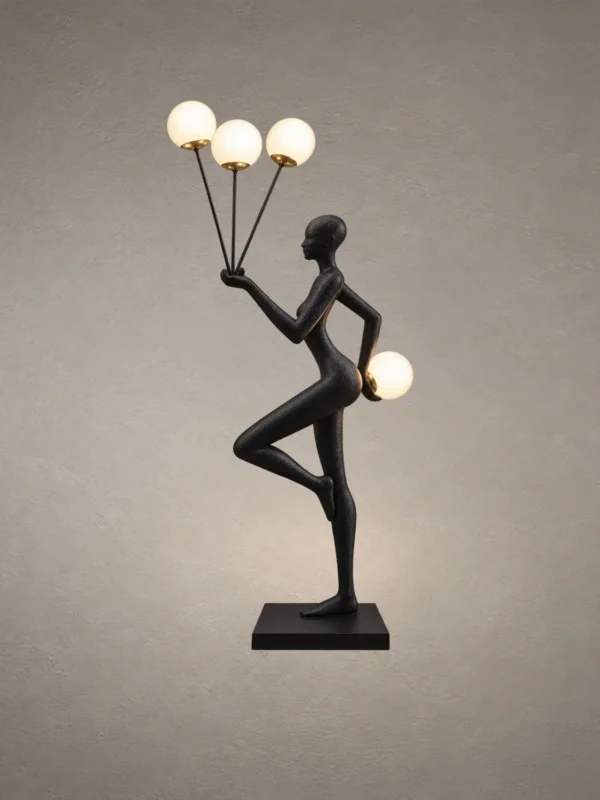 Humano Aria black sculptural floor lamp with a balancing human figure and four illuminated white globes