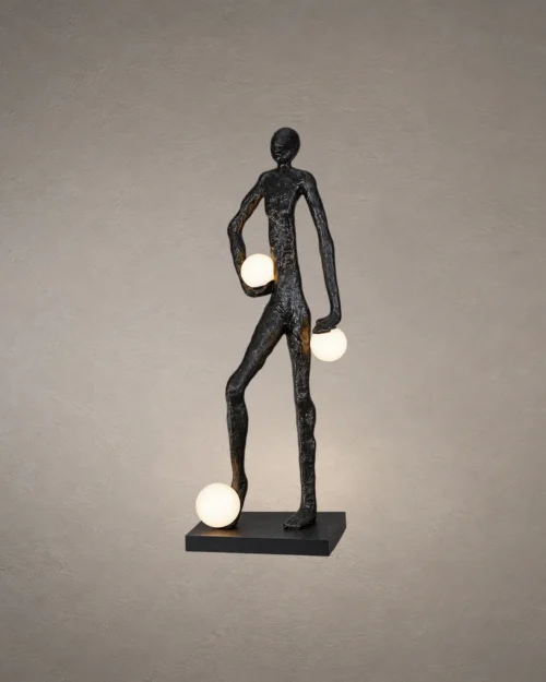 Humano Atlas black sculptural floor lamp featuring a walking human figure carrying three illuminated white globes