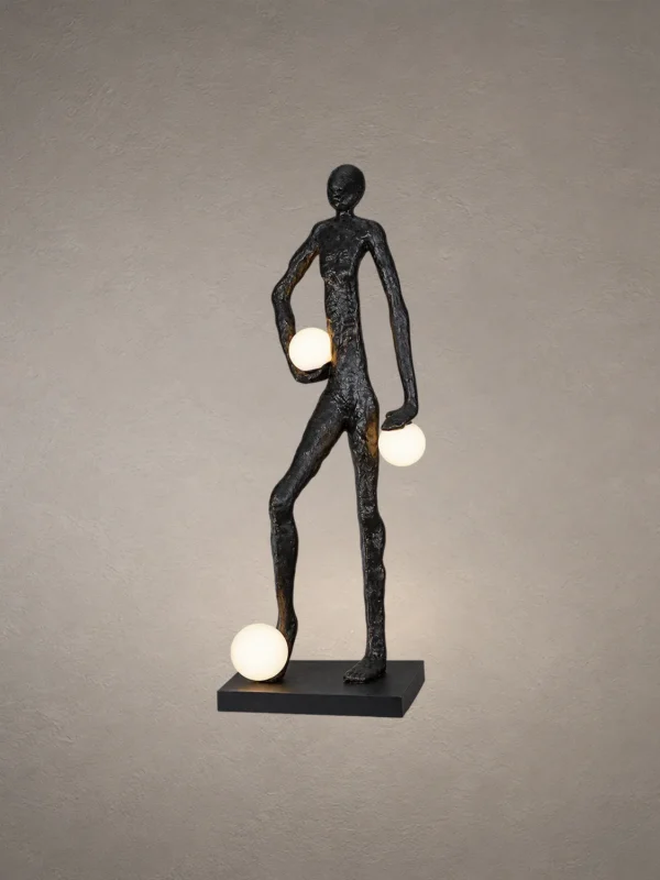 Humano Atlas black sculptural floor lamp featuring a walking human figure carrying three illuminated white globes