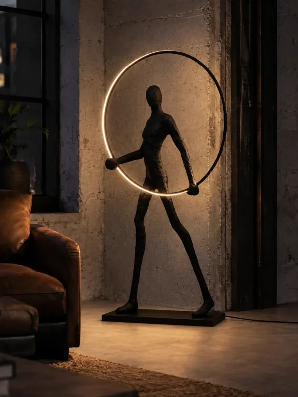 Humano Round sculptural black floor lamp illuminating a warm contemporary interior beside a window