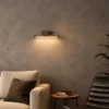 Kamari linear wall lamp with warm illumination in a modern interior