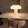 Kiel table lamp displayed on a dining table in a contemporary interior