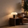 Kiel table lamp displayed beside a chair in a contemporary living room