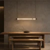 Kori 80 chandelier in Gun Black above a contemporary dining table