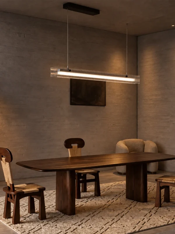 Linia linear chandelier suspended above a wooden dining table in a contemporary interior