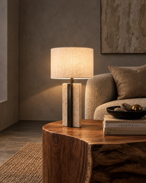 Lithos Table Lamp Living Room Lithos table lamp with white drum shade on a wooden side table beside an upholstered sofa