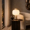 Milky Shine table lamp displayed beside a sofa in a contemporary living room