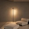 Mithra Floor Lamp Modern Living Room Mithra minimalist black floor lamp beside a contemporary upholstered lounge chair