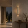 Miyake Strip Wall Lamp Modern Hallway Miyake Strip wall lamp illuminating a textured wall above a wooden console in a contemporary hallway