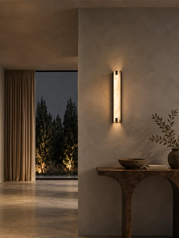 Miyake Strip wall lamp illuminating a textured wall above a wooden console in a contemporary hallway