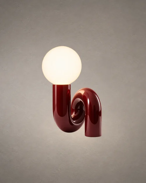 Noelle Maroon Sculptural Table Lamp Noelle modern maroon table lamp featuring a glowing spherical glass shade and curved resin base
