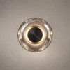 Orbe circular wall lamp featuring an illuminated ring and contrasting dark central accent
