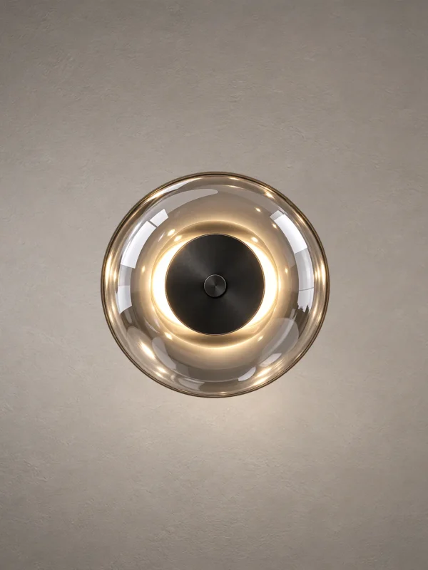 Orbe circular wall lamp featuring an illuminated ring and contrasting dark central accent