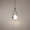 Orbit black and white pendant light with an illuminated spherical globe suspended within a triangular frame