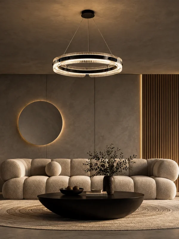 Oriel illuminated ring chandelier above a modern living room seating area with a curved sofa