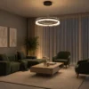 Oriel Chandelier Modern Living Room Oriel circular chandelier suspended above a contemporary living room with green upholstered seating