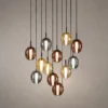 Osiris Colorful Glass Cluster Chandelier Osiris cluster chandelier featuring suspended oval glass pendants in multiple colors