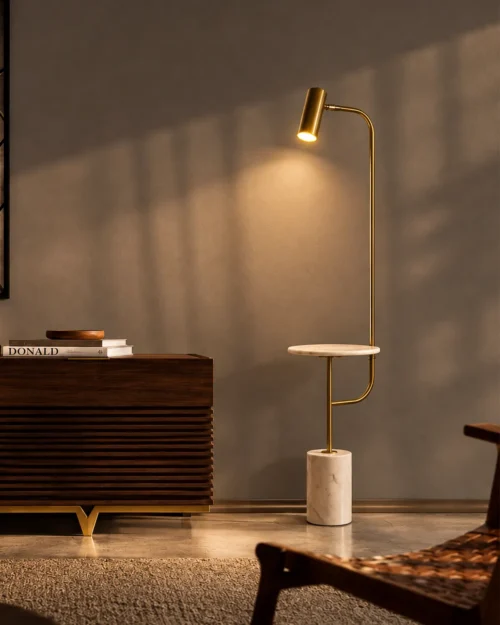 Radisson gold floor lamp with a white marble base beside a wooden cabinet in a contemporary interior